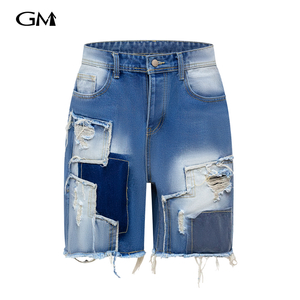 New denim shorts with torn fabric